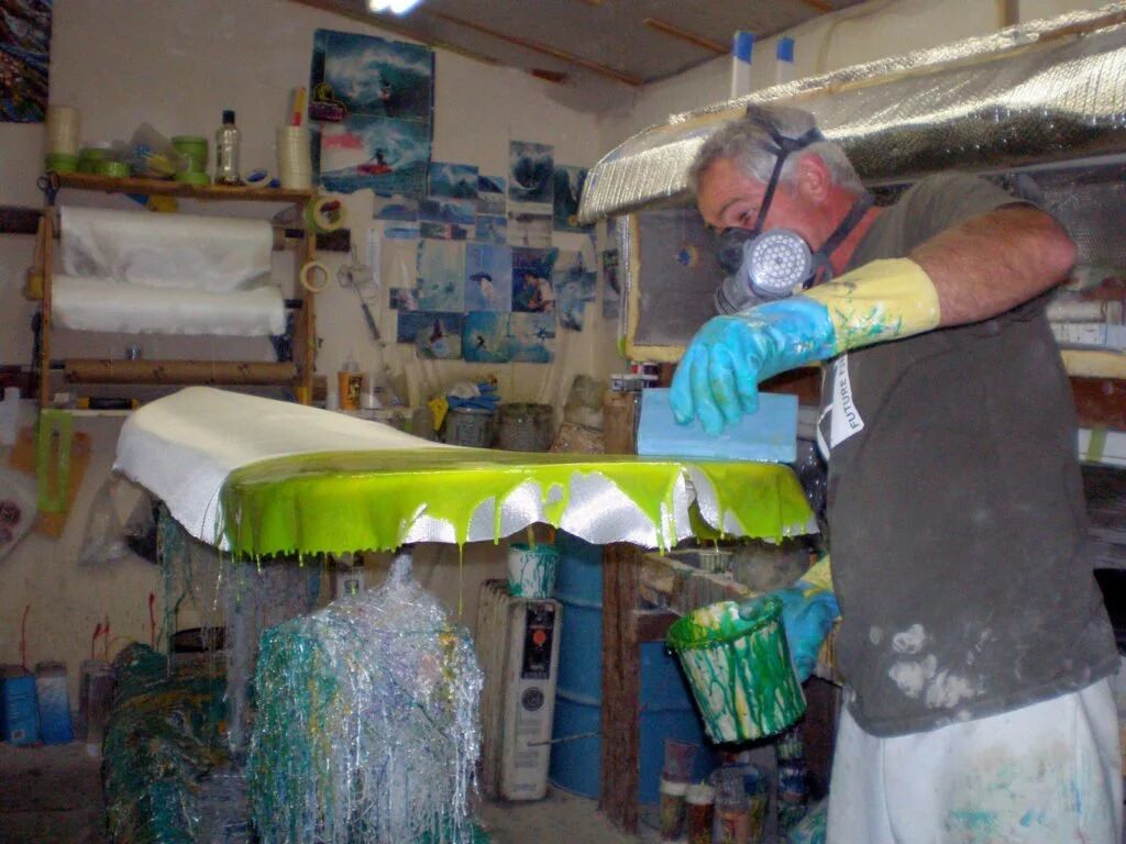 Vince Broglio hand-shaping a custom surfboard in his workshop